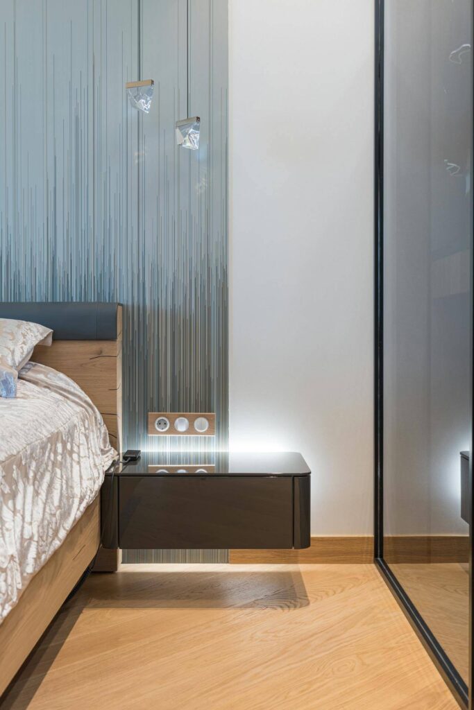 Floating nightstand in a small bedroom layout with a queen bed